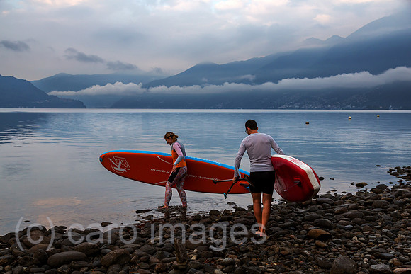 Schweiz, Ascona - Standup-Paddler am Lago Maggiore in der Morgendaemmerung