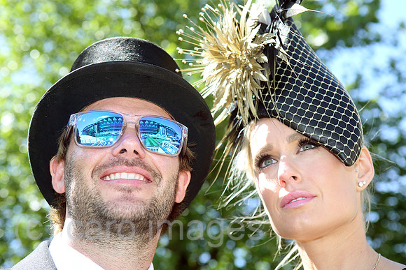 Royal Ascot, Fashion on Ladies Day, woman with hat and man with top hat at the racecourse