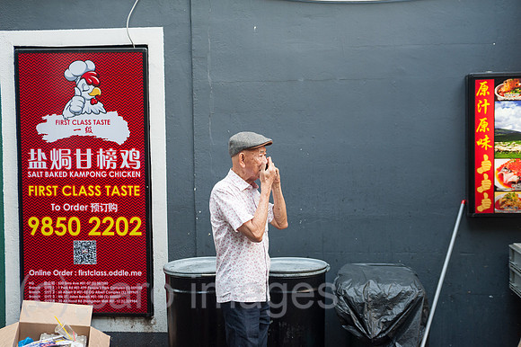 Singapur, Republik Singapur, Mann telefoniert in Chinatown