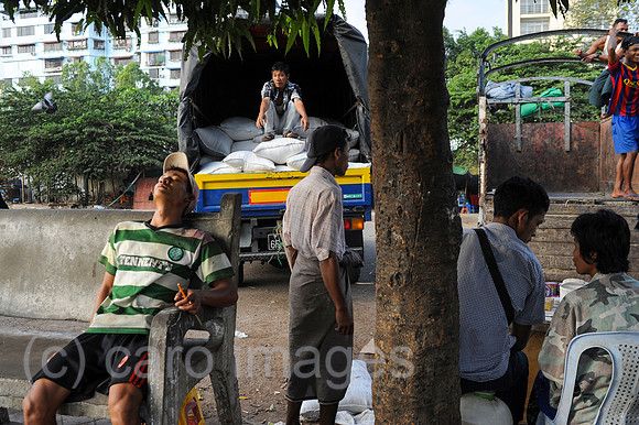 Yangon, Myanmar, Asien, Arbeiter beladen einen LKW mit Reissaecken