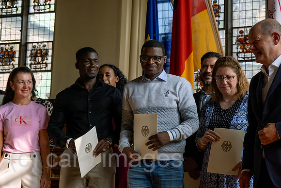 Deutschland, Bremen - Einbuergerungsfeier in der in der Oberen Rathaushalle, im Bild Neubuerger mit der Einbuergerungsurkunde, rechts Bundeskanzler Olaf Scholz