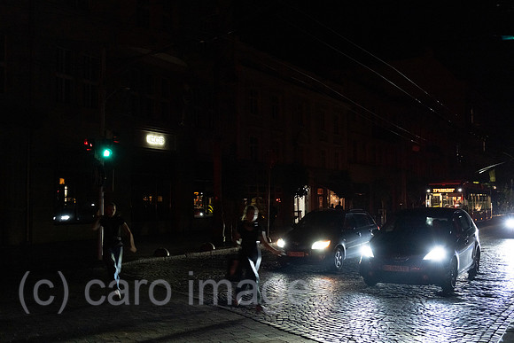Ukraine, Lviv - Pedestrians crossing the traffic lights on Prospekt Svobody in the dark, due to Russia's attacks on the energy infrastructure, power cuts occur repeatedly