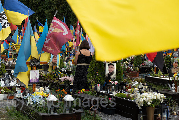 Ukraine, Lviv - Family member mourning at a grave on the Field of Mars, a cemetery of honour for Lviv soldiers who died in the war in Ukraine