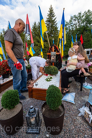 Ukraine, Lwiw - Witwe mit ihren Eltern und Tochter am Grab ihres Manns auf dem Marsfeld, Ehrenfriedhof der gefallenen Lwiwer Soldaten im Ukrainekrieg