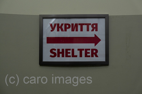Ukraine, Lviv - English-Ukrainian sign in hotel for air-raid shelter