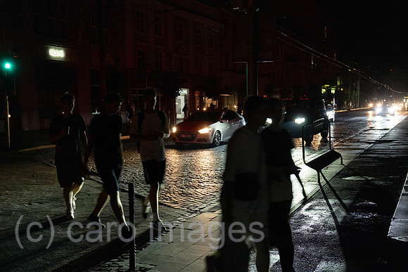 Ukraine, Lviv - pedestrians cross the traffic lights on Prospekt Svobody in the dark, due to Russia's attacks on the energy infrastructure, there are frequent power outages